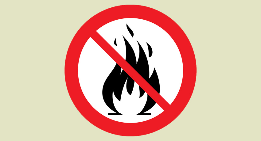 En symbol för eldningsförbud med en eld med ett rött streck över.